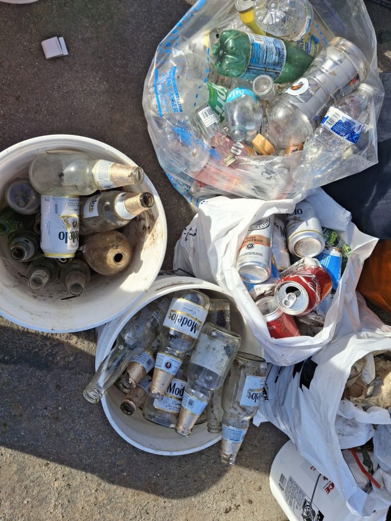 Buckets and trash bags filled with recyclables