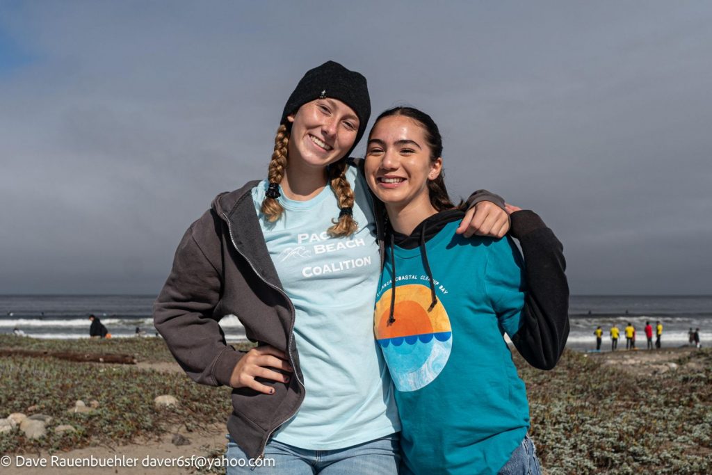 Two female volunteers pose at a cleanup event