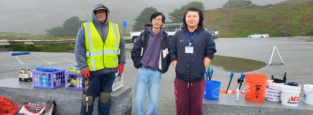 An adult and two youth volunteers get ready for a Pacific Beach Coalition cleanup