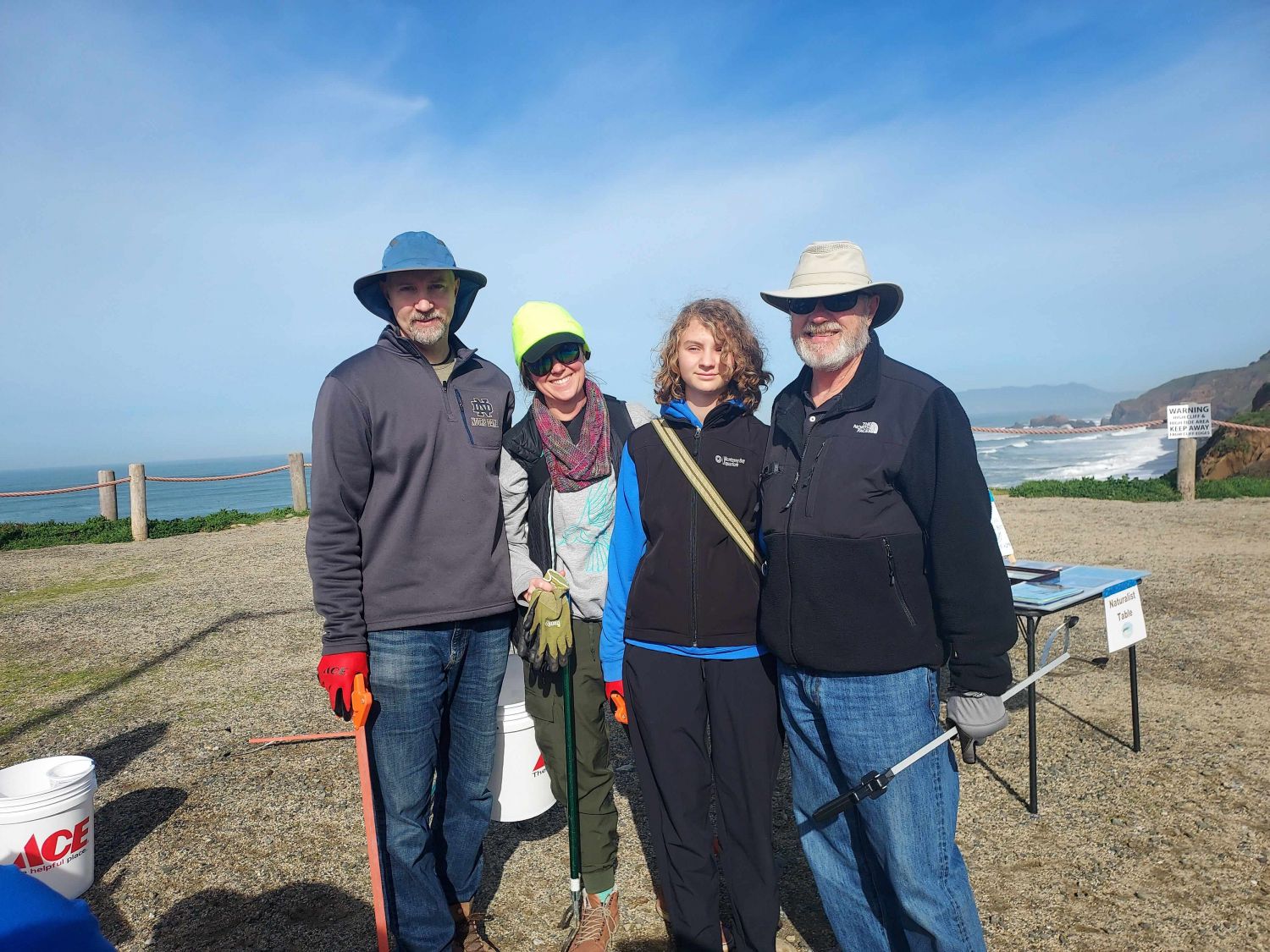 Four volunteers pose at a February 2025 PBC cleanup