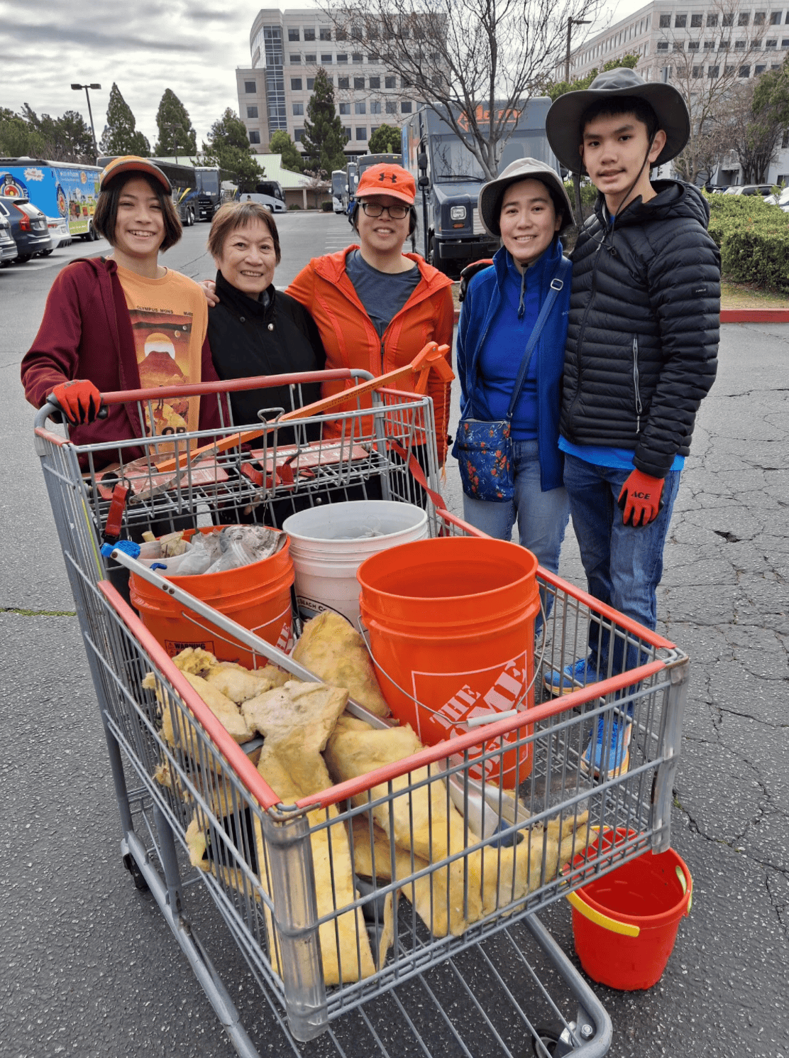 A family of five across four generations poses with supplies at a February 2025 PBC cleanup